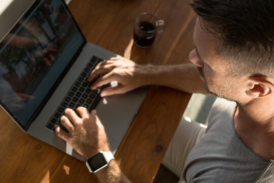 Mature man working on laptop, close-up