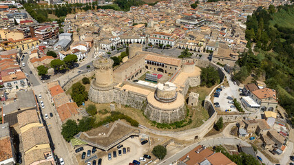 Fototapeta premium Aerial view on the Aragonese Castle of Venosa, a small town in province of Potenza, Basilicata, Italy. It's a a majestic medieval fortification with circular towers and stone fortifications.