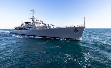 Navy ship patrolling the sea during military operation. © ValStock