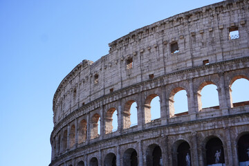 Fototapeta premium Colosseum (Coliseum) building or Flavian Amphitheatre in Rome, Lazio, Italy. Architectural monument of Ancient Rome. Close up view of the Colosseum, highlighting arches and aged stone. 