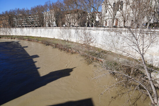 The view from the ancient Cestius Bridge or Ponte Cestio over the Tiber River, among the island Tiberina and Trastevere quarter. Rome, Lazio, Italy. Tiber River in the end of February. Holidays. 