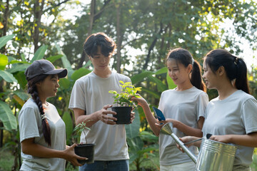 Obraz premium Group of Asian people holding seedling and tools for planting