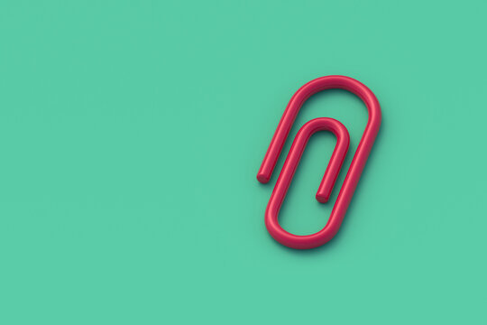 Paper clip on green background. Office supplies. School accessories. Stationery item. Copy space. 3d render