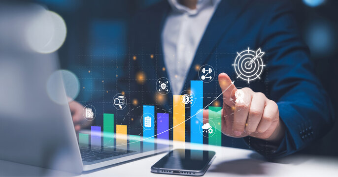 Investing for financial growth: businessman using laptop with virtual chart to analyze income and wages increase, economic improvement, and investment portfolio profitability.