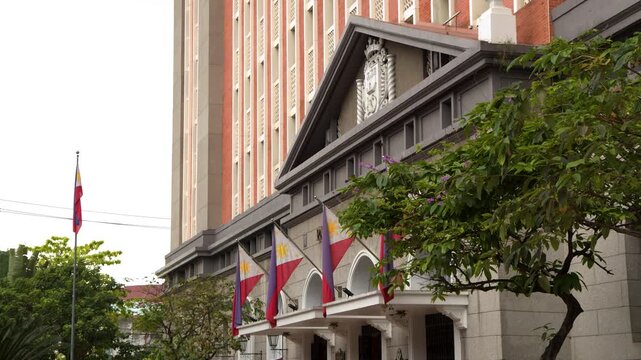 Manila City Hall Building with Filipino Flags Waving in the Wind