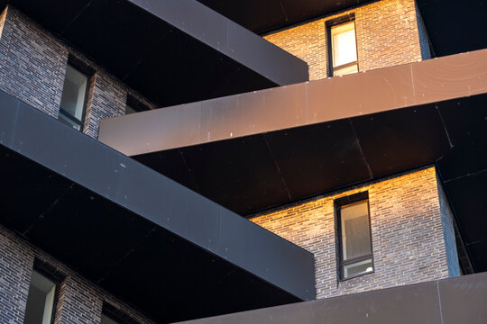 Modern Copenhagen building exterior shows residential facade with windows shadows and geometry in architecture design for real estate development branding