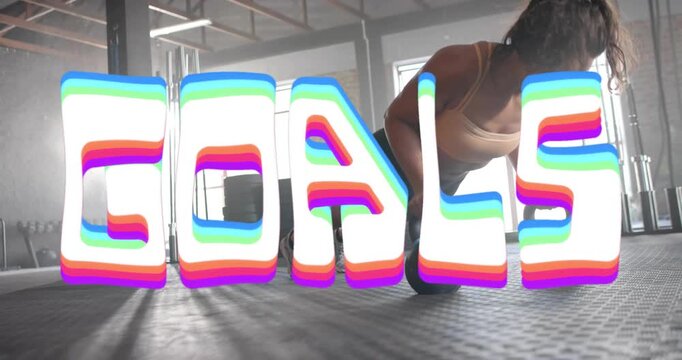 Woman initiating med ball push-ups in gym, building strength while GOALS graphic overlaying scene