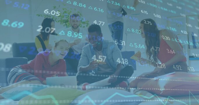 Working group of six casually dressed adults in lounge with laptops, pizza and financial overlay