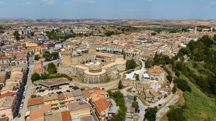 Fototapeta premium Aerial view of the historic center of Venosa, a small town in province of Potenza, Basilicata, Italy. At the center is the Aragonese Castle, a historic fortified building and attraction of the city.