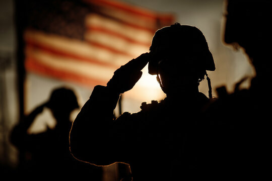SIlhouette of american patriot soldiers saluting the US flag in the background, army and military honor and pride, memorial day or veterans day, killed soldiers tribute
