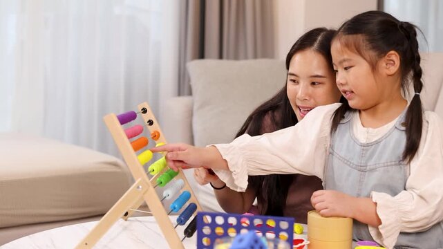 Mother and Daughter Learning with Abacus at Home