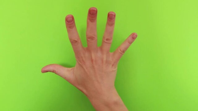 Female hand counting from one to five on green background. Finger counting gesture isolated on chroma key. Education, numbers and step by step concept.