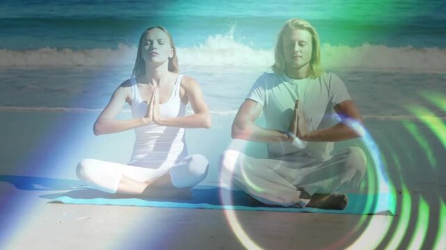 Duo meditating on blue mat, sequence starting with hands praying and light rings sweeping for calm