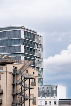 Modern urban skyline with a tall building tower and windows under shifting clouds presenting architecture city design and clean lines in a contemporary profile