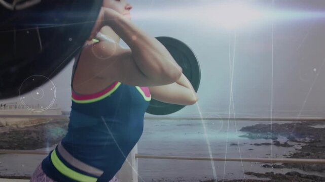Female weightlifter gripping bar, lifting into overhead lockout for fitness with animated flares