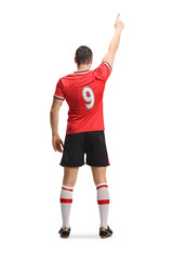 Rear view shot of a football player in a red jersey standing and pointing