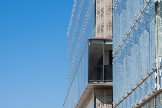 Modern architecture building facade exterior with windows in urban sky featuring reflective glass tower design and structure detail