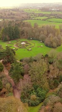 Wide vertical social ratio 60FPS aerial video of Sir Thomas and Lady Dixon Park in Belfast, Northern Ireland on a sunny day. Produced with Rec709 color.
