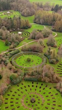 Advancing vertical social ratio 60FPS aerial video of Sir Thomas and Lady Dixon Park in Belfast, Northern Ireland on a sunny day. Produced with Rec709 color.