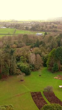 Reversing vertical social ratio 60FPS aerial video of Sir Thomas and Lady Dixon Park in Belfast, Northern Ireland on a sunny day. Produced with Rec709 color.