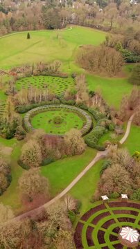 Travelling vertical social ratio 60FPS aerial video of Sir Thomas and Lady Dixon Park in Belfast, Northern Ireland on a sunny day. Produced with Rec709 color.