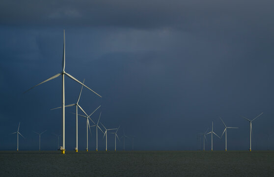 Offshore windfarm with snowclouds over IJsselmeer lake in Netherlands