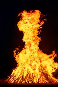 Large solstice bonfire at night outdoors