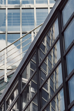 Modern architecture facade with steel framework lines and diagonal windows plus urban reflections creating a strong background for design