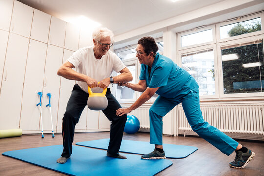 Physiotherapy session with nurse assisting patient in indoor training