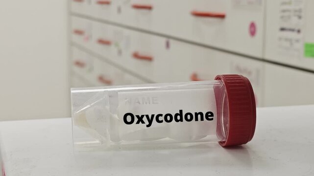 Box of Oxycodone opioid pain relief medication placed on pharmacy table OXYCODON