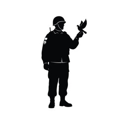 Obraz premium Soldier holding a bird in his hand standing alone peacefully