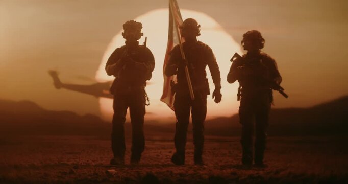 Silhouette of Three Soldiers walk Through a Desert at Sunset Carrying United States Flag, Military Helicopter Flies in Background. Patriotic Valor, Freedom Fighting, Peace Mission, Warfare, Conflict.