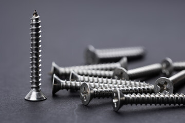 Tapping screws made of steel on Gray background, metal screw, iron screw, chrome screw,
