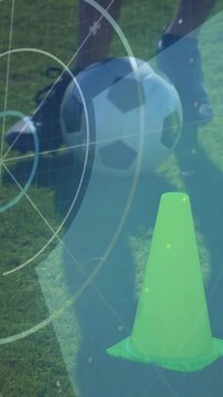 Right foot touching ball, soccer trainee nudging and dragging ball around cone, practicing control