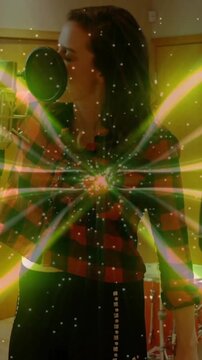 Singer breathing then singing into pop mic, creating starburst over chest during recording