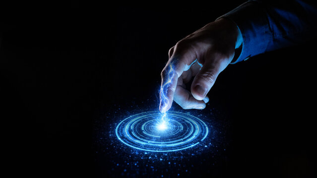 Human finger touching glowing holographic interface and digital energy circle. Concept of futuristic control systems, gesture interaction, virtual interface design and advanced technology navigation.