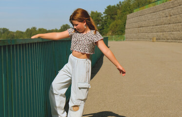 Fototapeta premium Happy girl enjoying walking, dancing, jumping. Freedom and carefree. Happy childhood. Activity summer vacations. Lifestyle photography