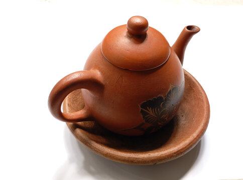 Traditional Clay Teapot and Saucer on White Background