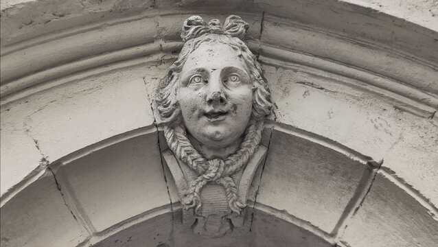 Stone mascaron on historic arch detail