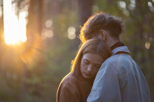 A loving couple hugging in the forest, a relationship crisis and separation