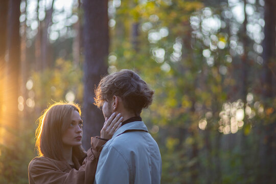 A loving couple hugging in the forest, a relationship crisis and separation