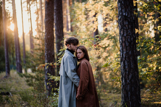 A loving couple hugging in the forest, a relationship crisis and separation