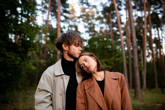 A loving couple hugging in the forest, a relationship crisis and separation