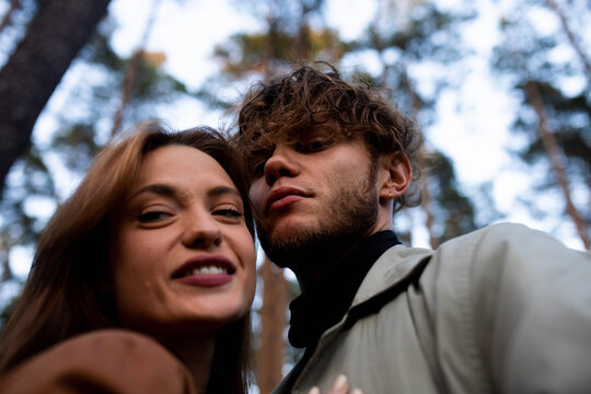 A selfie of a young beautiful couple on a walk in the forest
