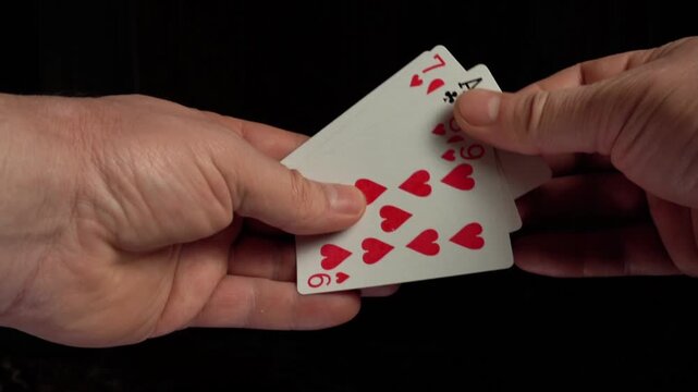 A player receives an ace of clubs from a deck of cards, demonstrating a winning high card combination during a poker game
