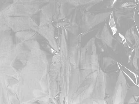 transparent packaging material plastic wrap film cling cellophane stretch wrinkled texture reflective highlights isolated realistic