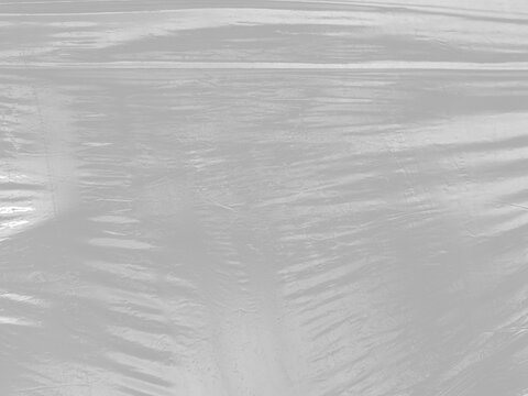 shrink wrap film packaging material wrinkled crumpled creased folded texture transparent reflective isolated