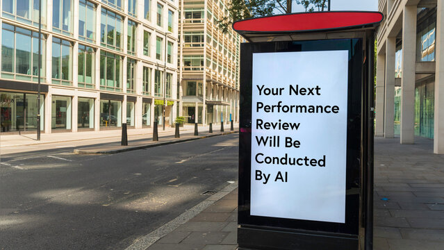 London bus stop digital billboard displaying a message about AI conducting performance reviews