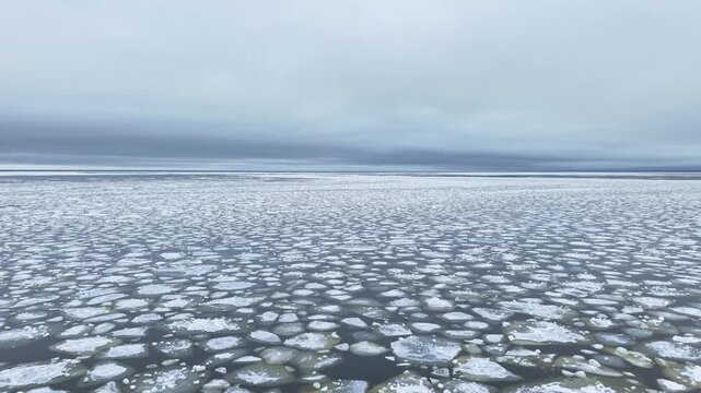 Frozen Baltic Sea view with broken ice floes in winter, calm and cold atmosphere