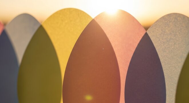 Vibrant surfboard tails in various colors at sunset